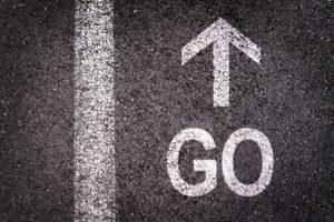 word go and an arrow written on an asphalt road background